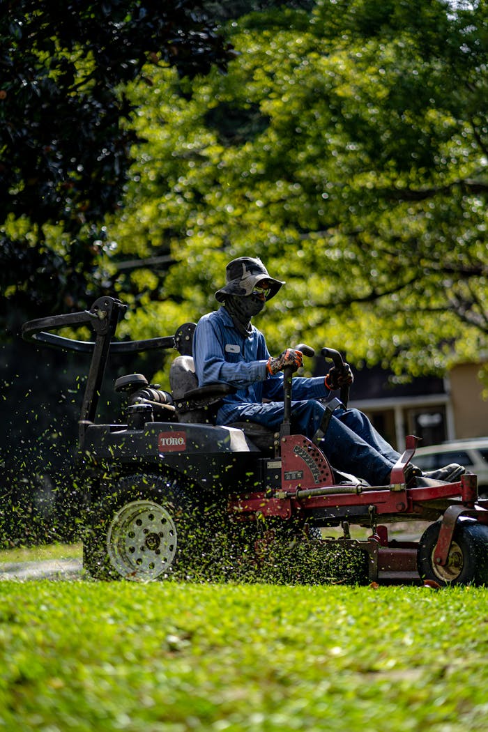 Why ServiceFusion's Customer Export Keeps Failing (And What You Can Do About It) Person on a lawn mower cutting grass in a sunny, green park.